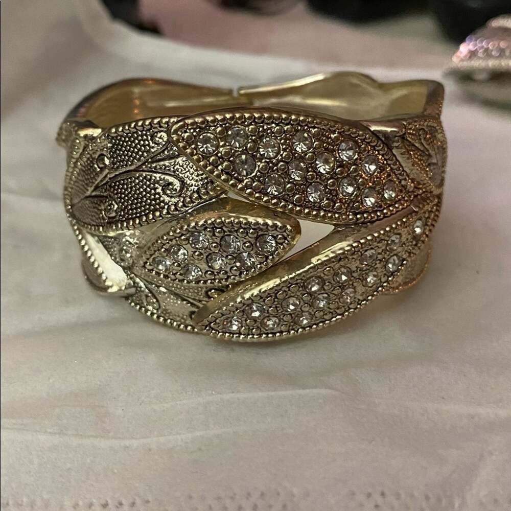 Silvertone bracelet with faux clear stones hinged closure intricate design